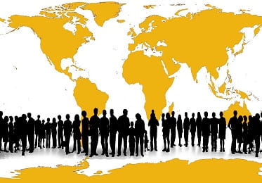 silhouettes of many people in front of a world map