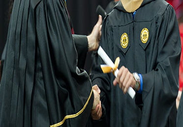 a person receiving their diploma at a ceremony