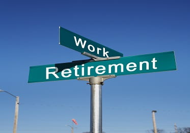 two perpendicular street signs that say work and retirement